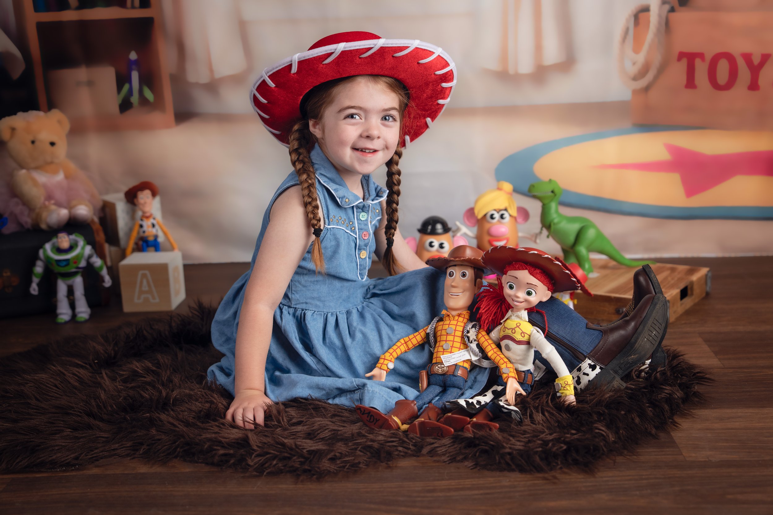 Child enjoying an imaginative portrait session in Andy's Room