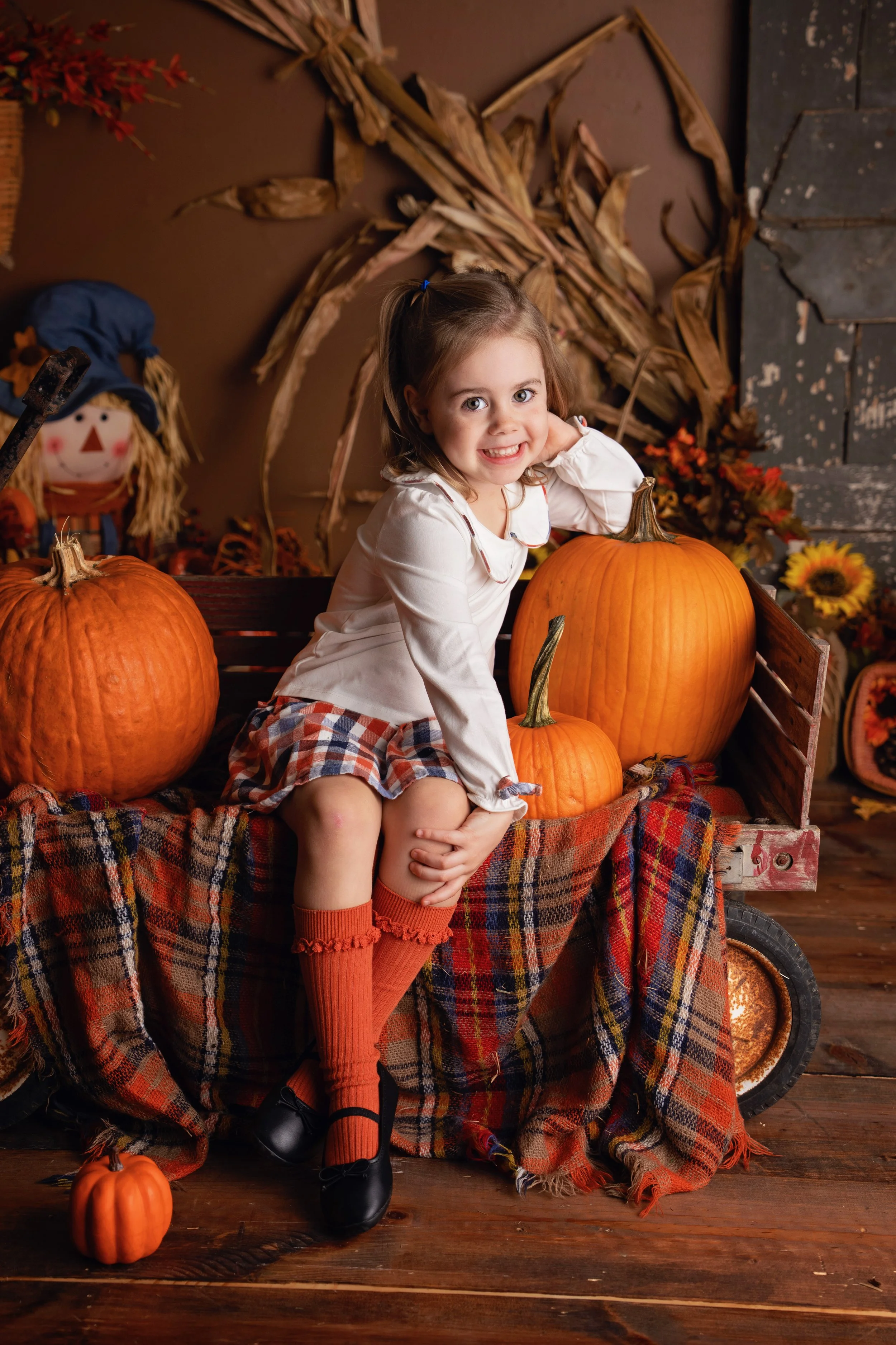 Studio portrait with pumpkins and autumn leaves