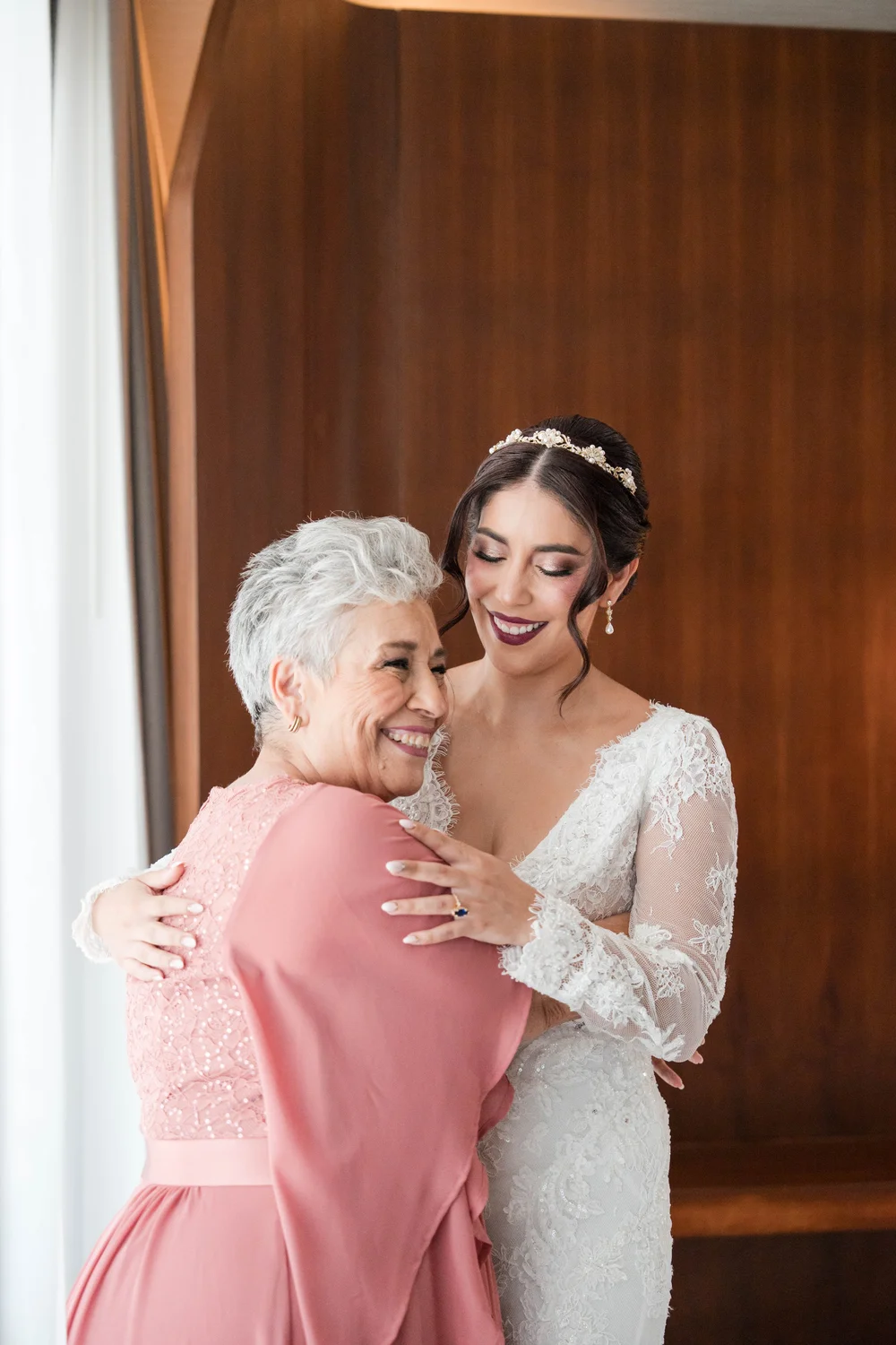 A bride embracing her mother in the quiet moments before the ceremony