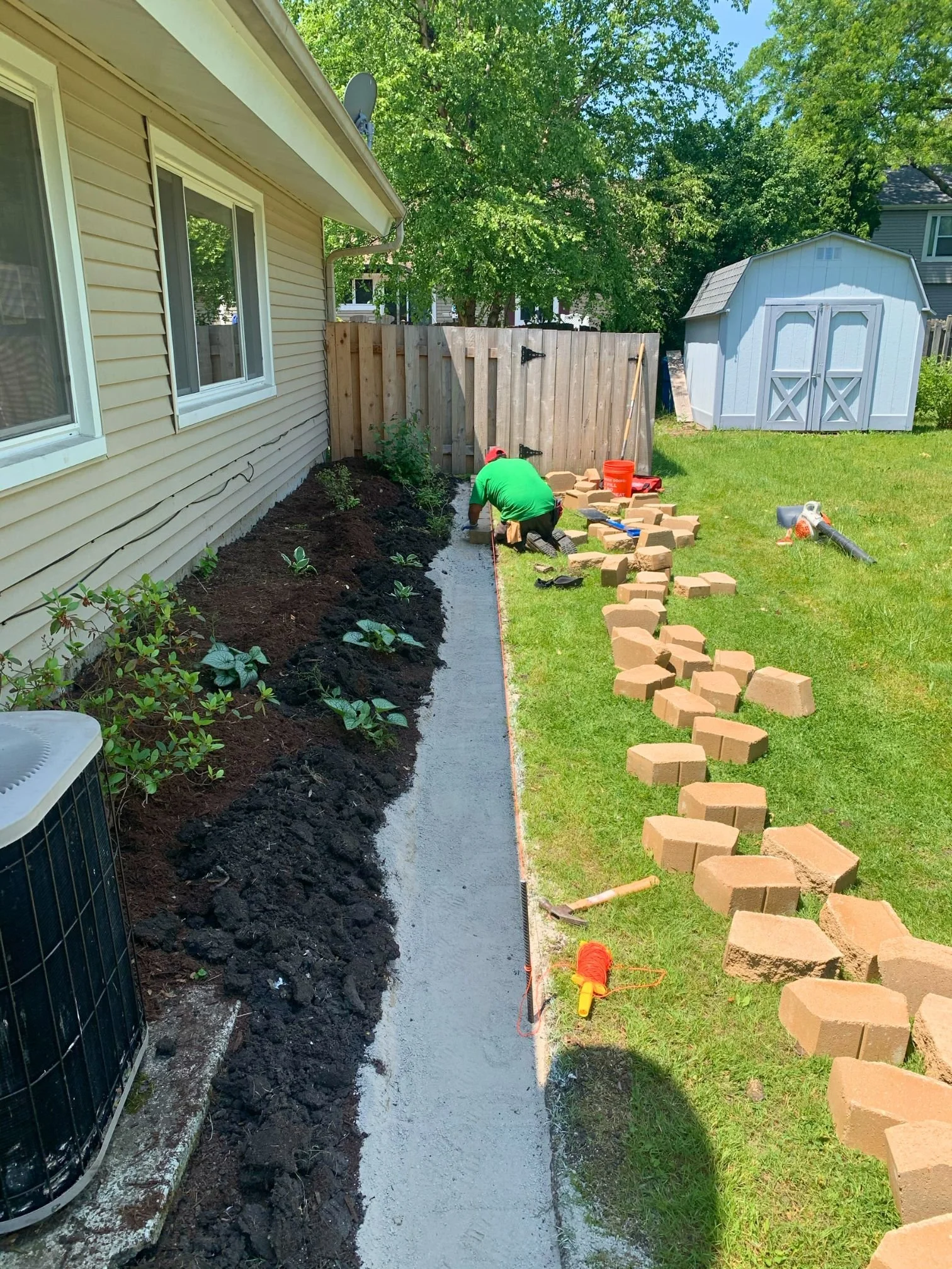Side-yard retaining wall installation in progress in Roselle, Illinois.