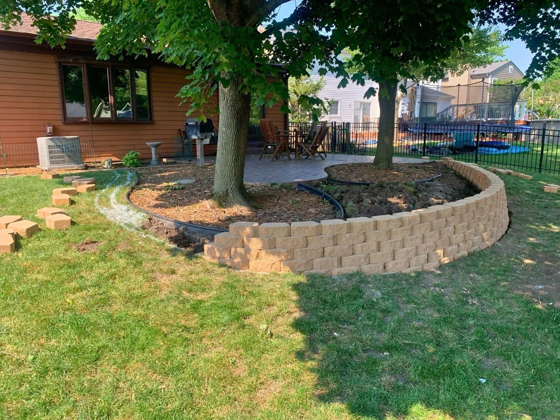 Tall curved retaining wall installation in Bloomingdale, Illinois.