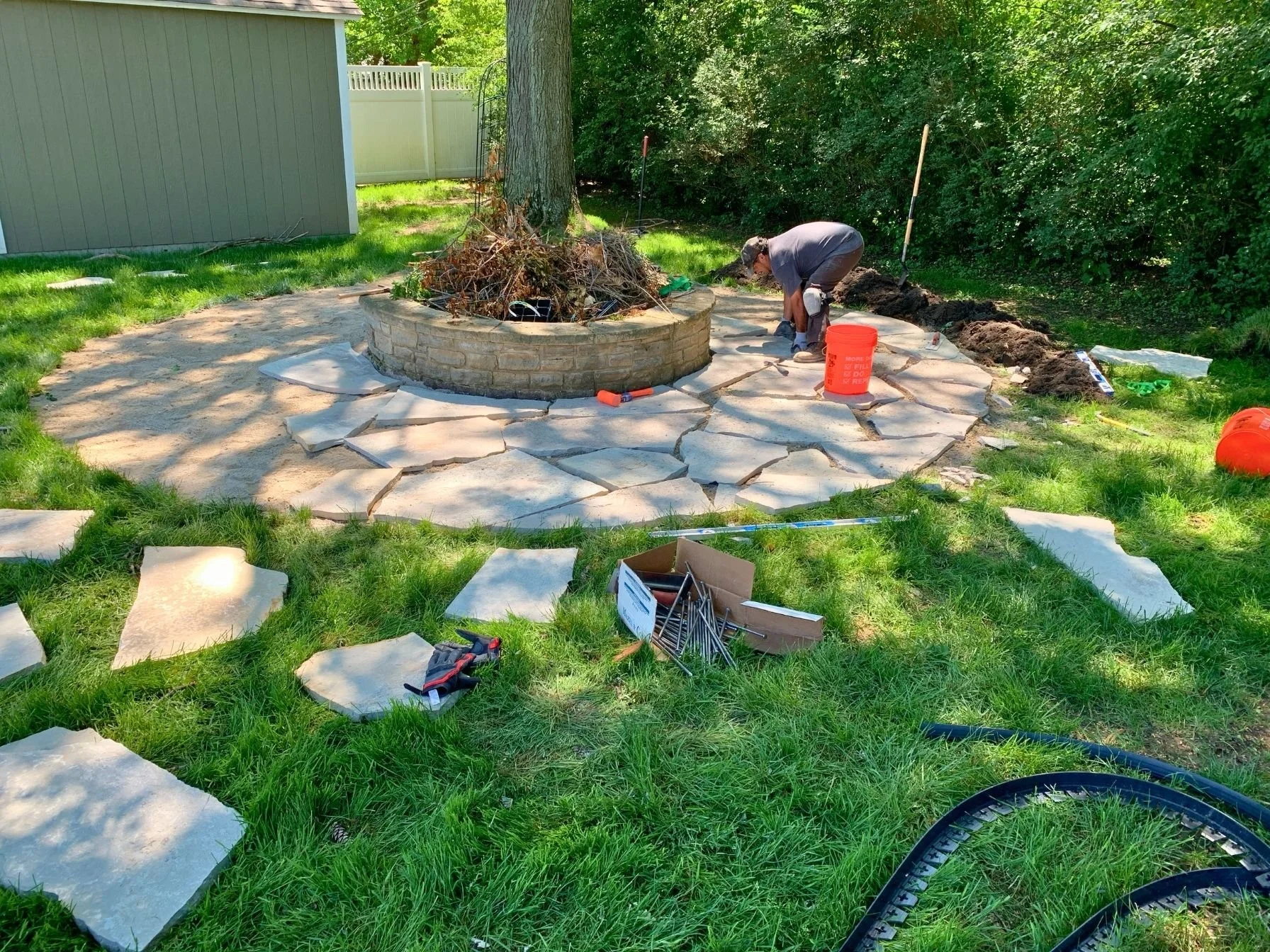Flagstone fire pit patio installation in progress in Schaumburg, Illinois.