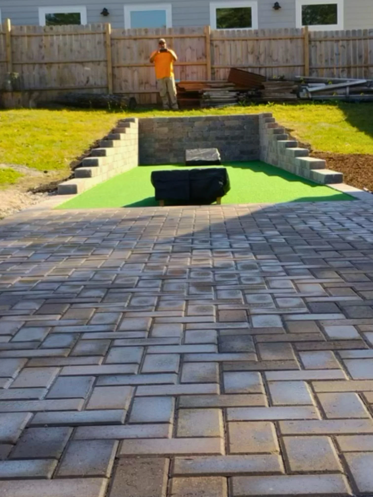 Paver patio turf cornhole area in Roselle, Illinois.