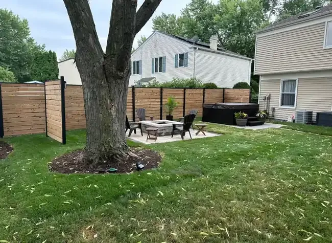 Backyard privacy fence fire pit hot tub pad in Roselle, Illinois.