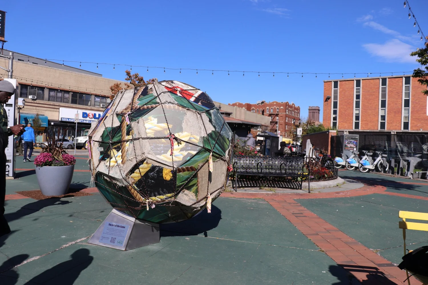 Nyugen E. Smith soccer ball sculpture in the McGinley Square Plaza
