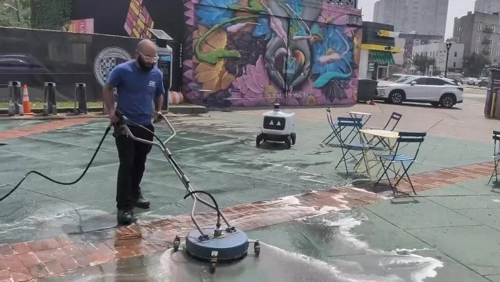 CDS crew power washing the plaza