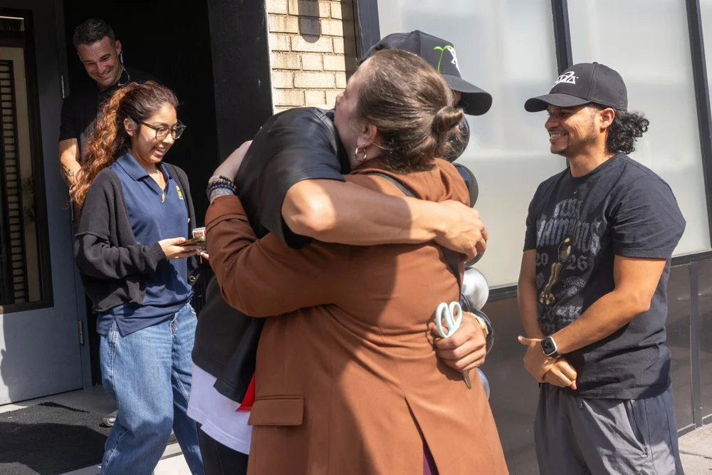 A hug outside XENA on opening day