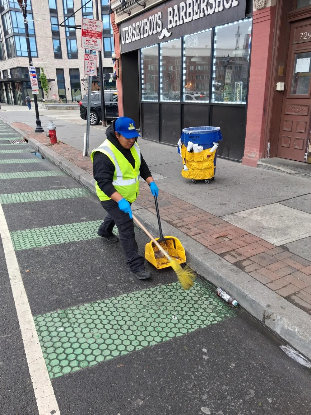 CDS crew member sweeping in McGinley Square