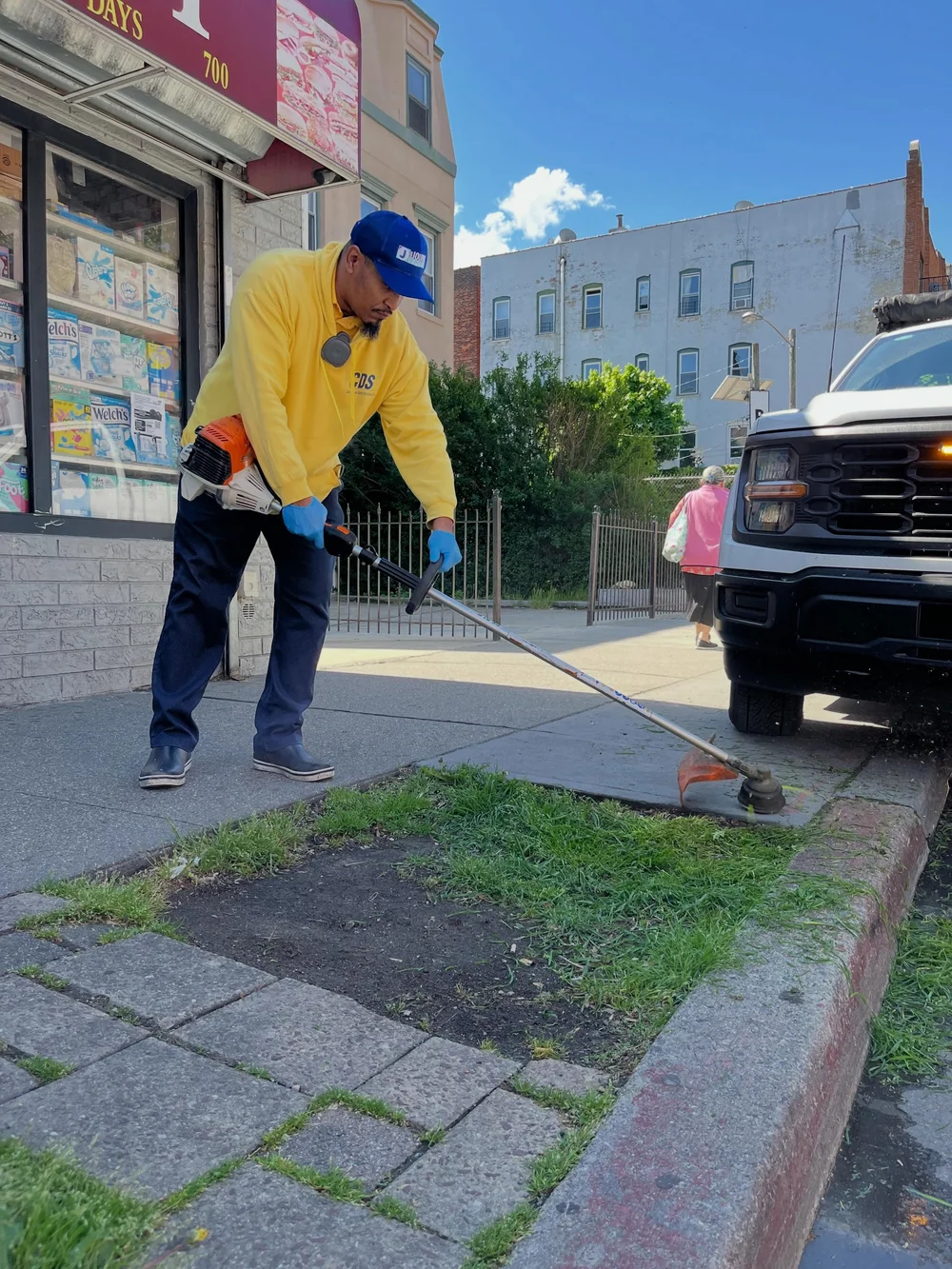 CDS crew member pulling weeds