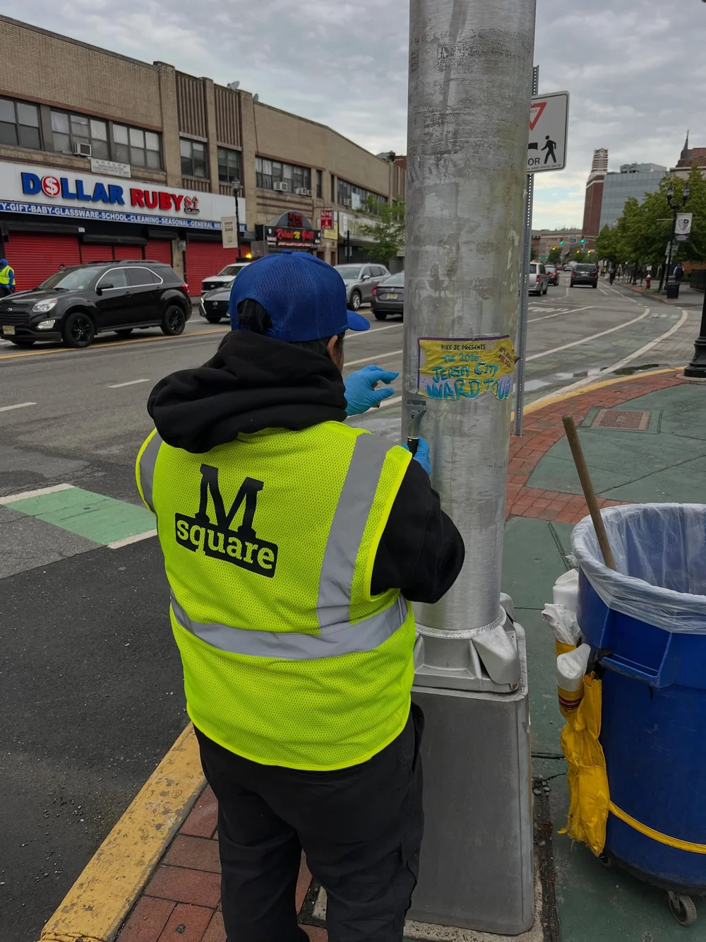 CDS crew member removing posters from a pole