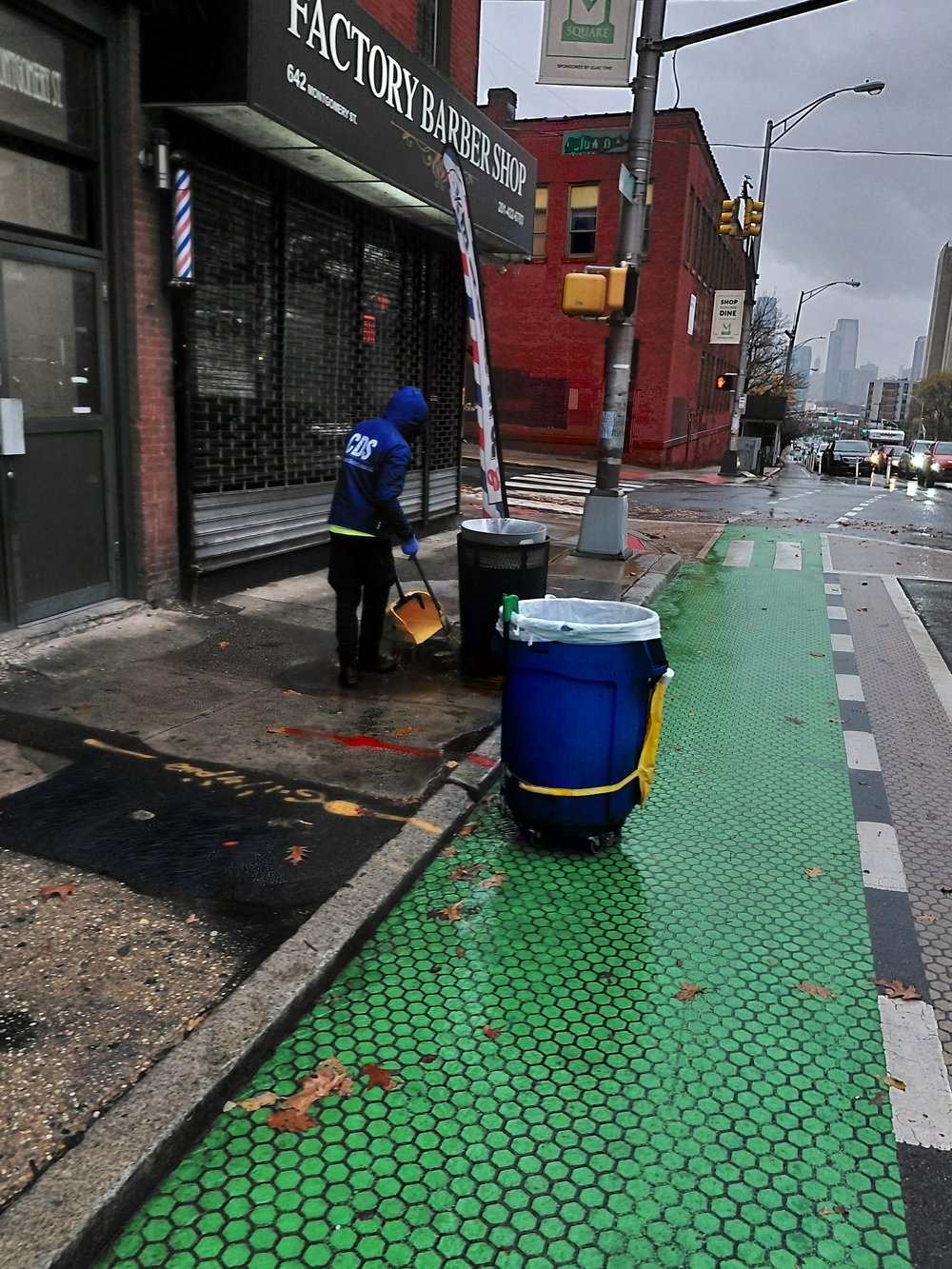 CDS crew cleaning a sidewalk and bike lane
