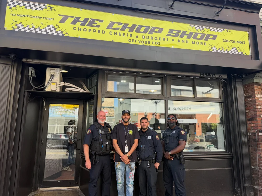 Off-duty officers with Haytham in front of The Chop Shop