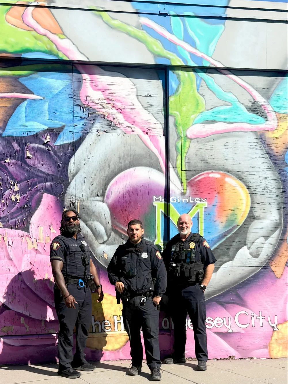Officers at the McGinley Square heart mural