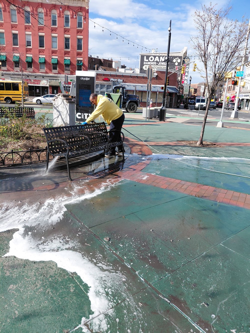 Power washing a McGinley Square sidewalk