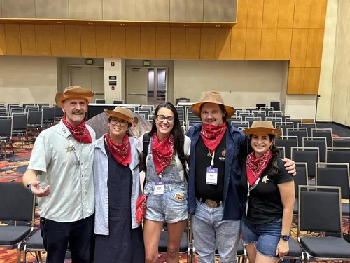 Five participants in cowboy hats and bandanas at LIFE 2025