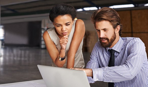A man and woman in thought looking at a tablet