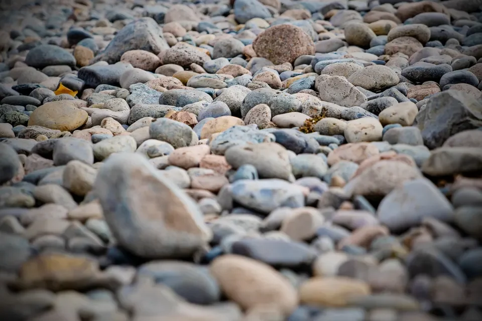 Rounded shoreline pebbles fill an intimate, softly focused coastal photograph.