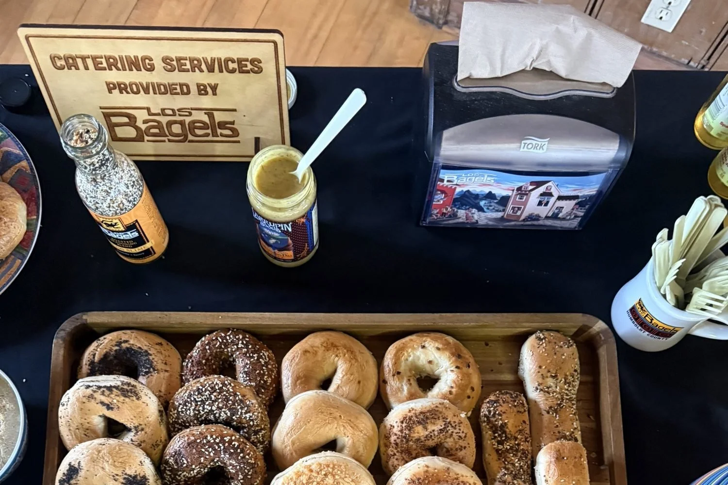 Catered bagel spread with Los Bagels signage