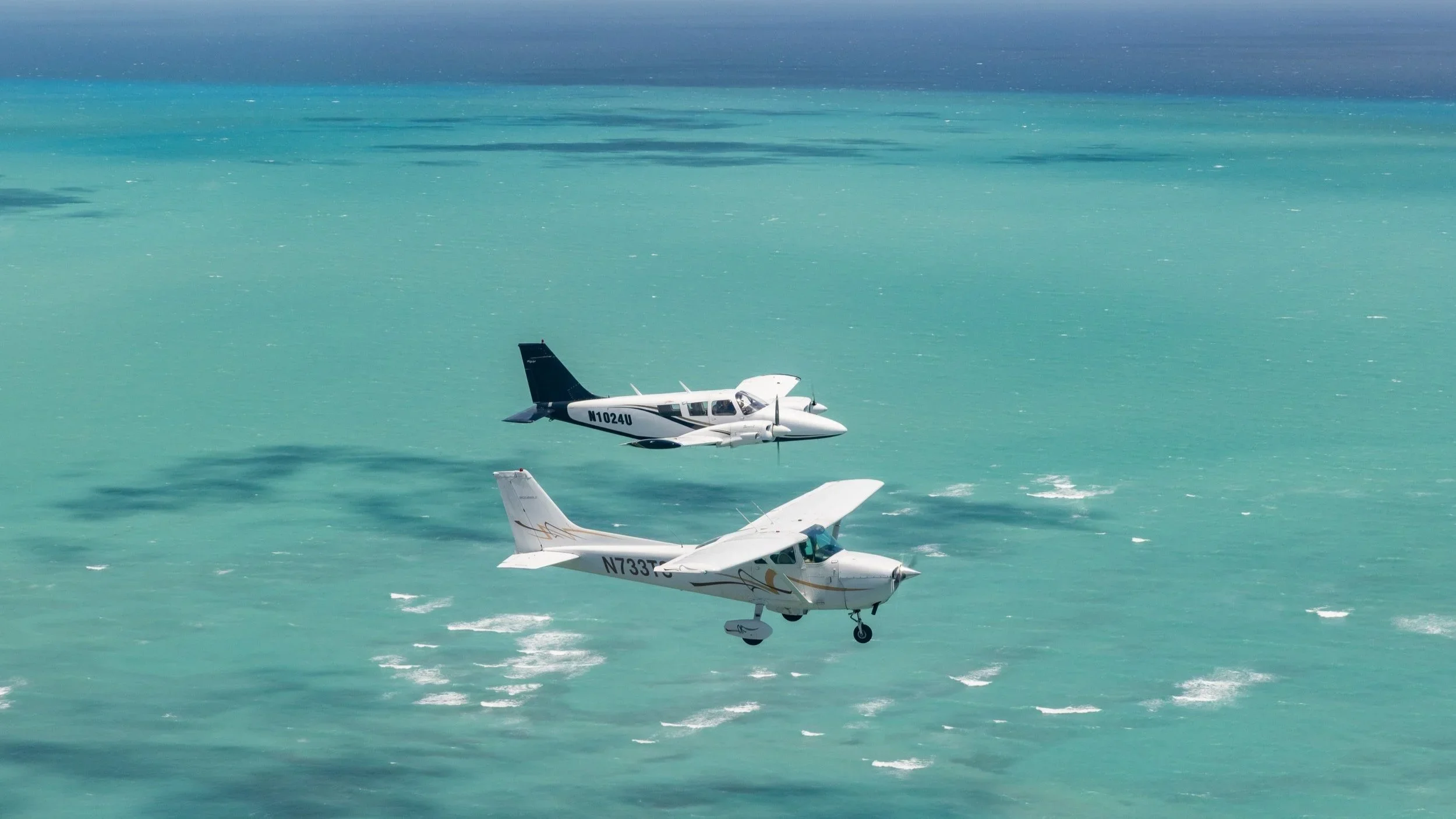 Flight Center International Academy fleet flying over Miami coastline