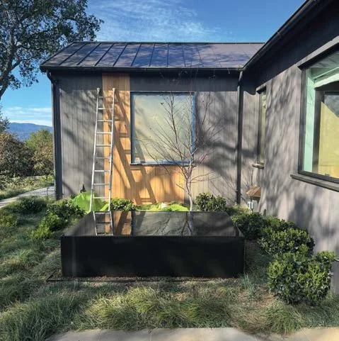 Exterior home project with protected windows and siding work in progress
