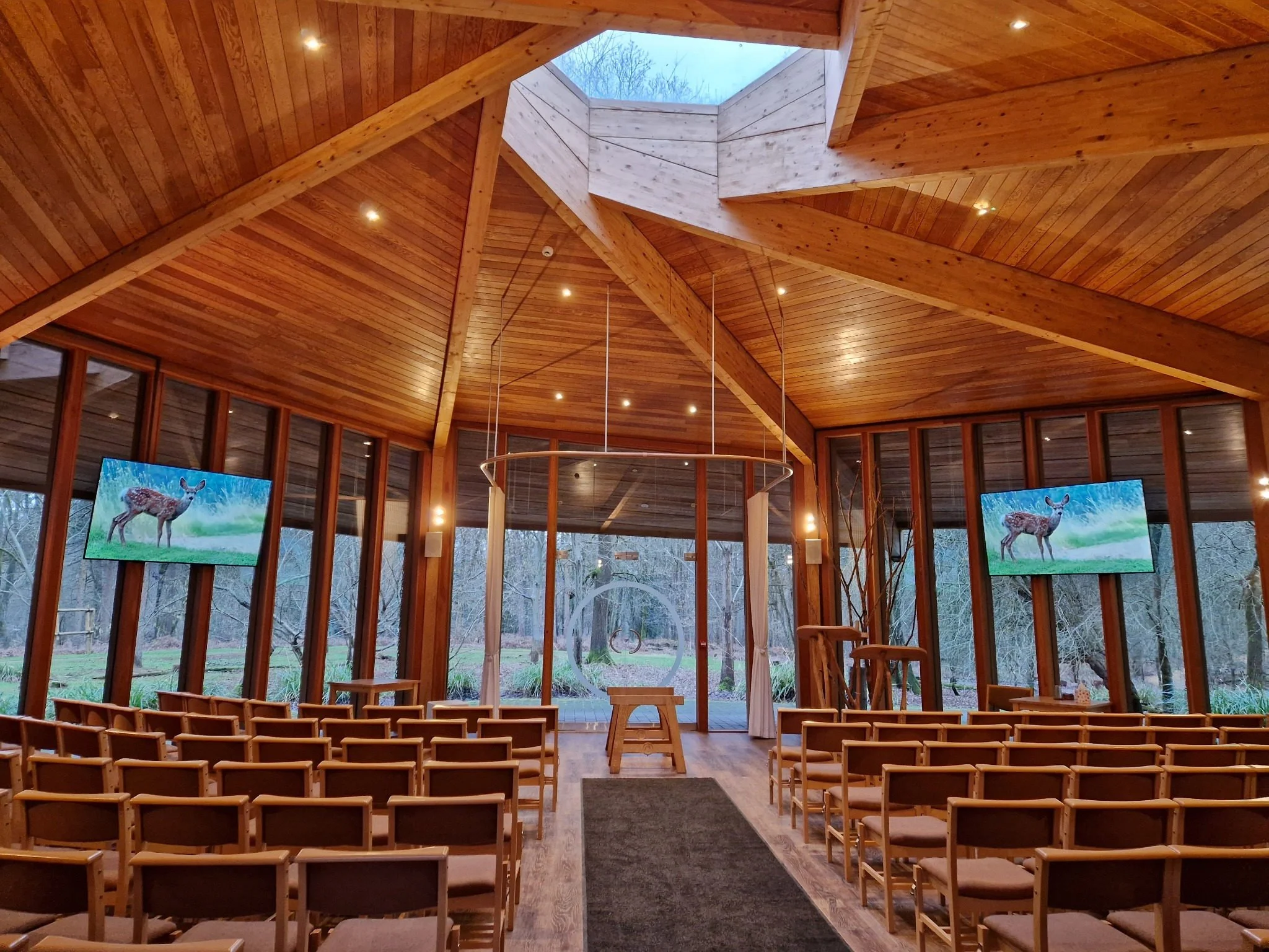 The light-filled Woodland Hall at GreenAcres Chiltern Park with views of the trees beyond the windows