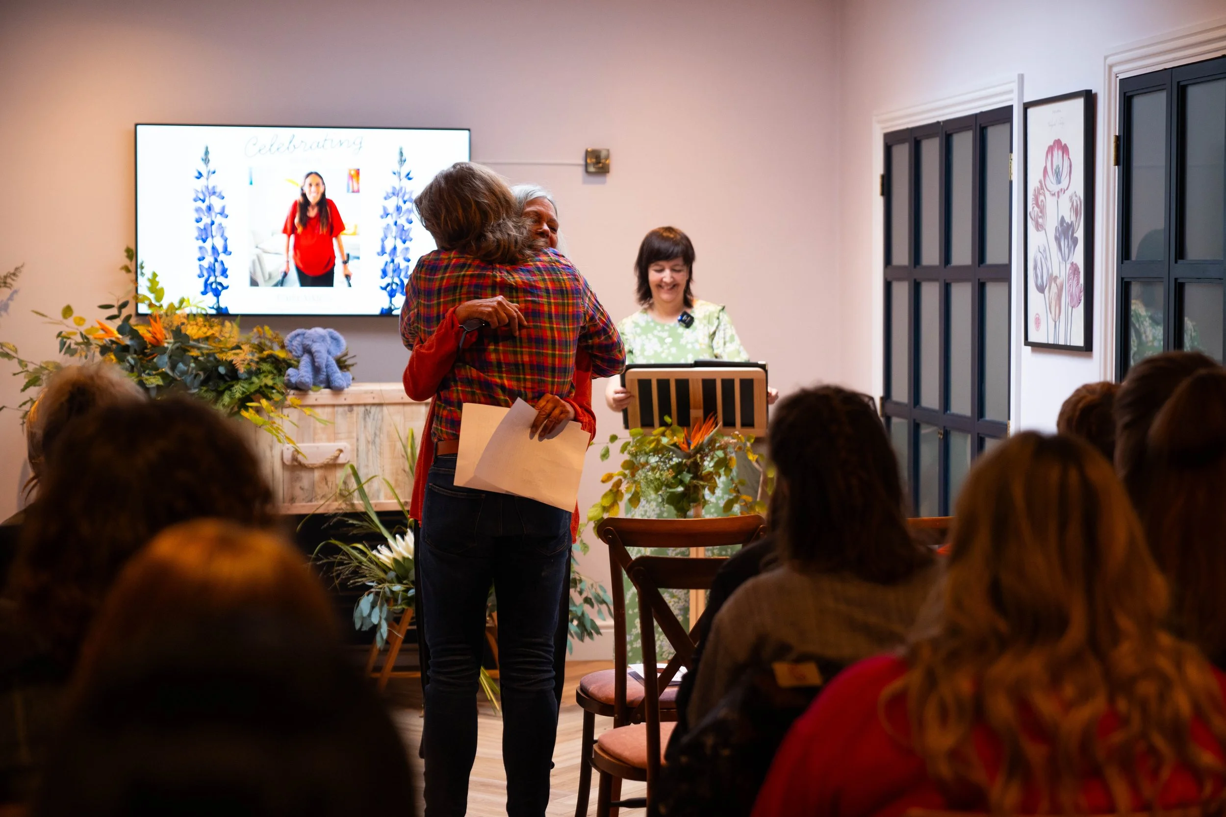 Two people embracing during a funeral arranged by Poetic Endings