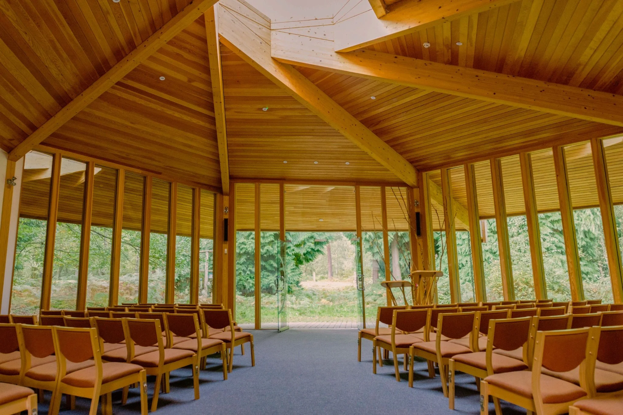 Interior of the Woodland Hall at GreenAcres Epping Park, with seating and views towards the woodland