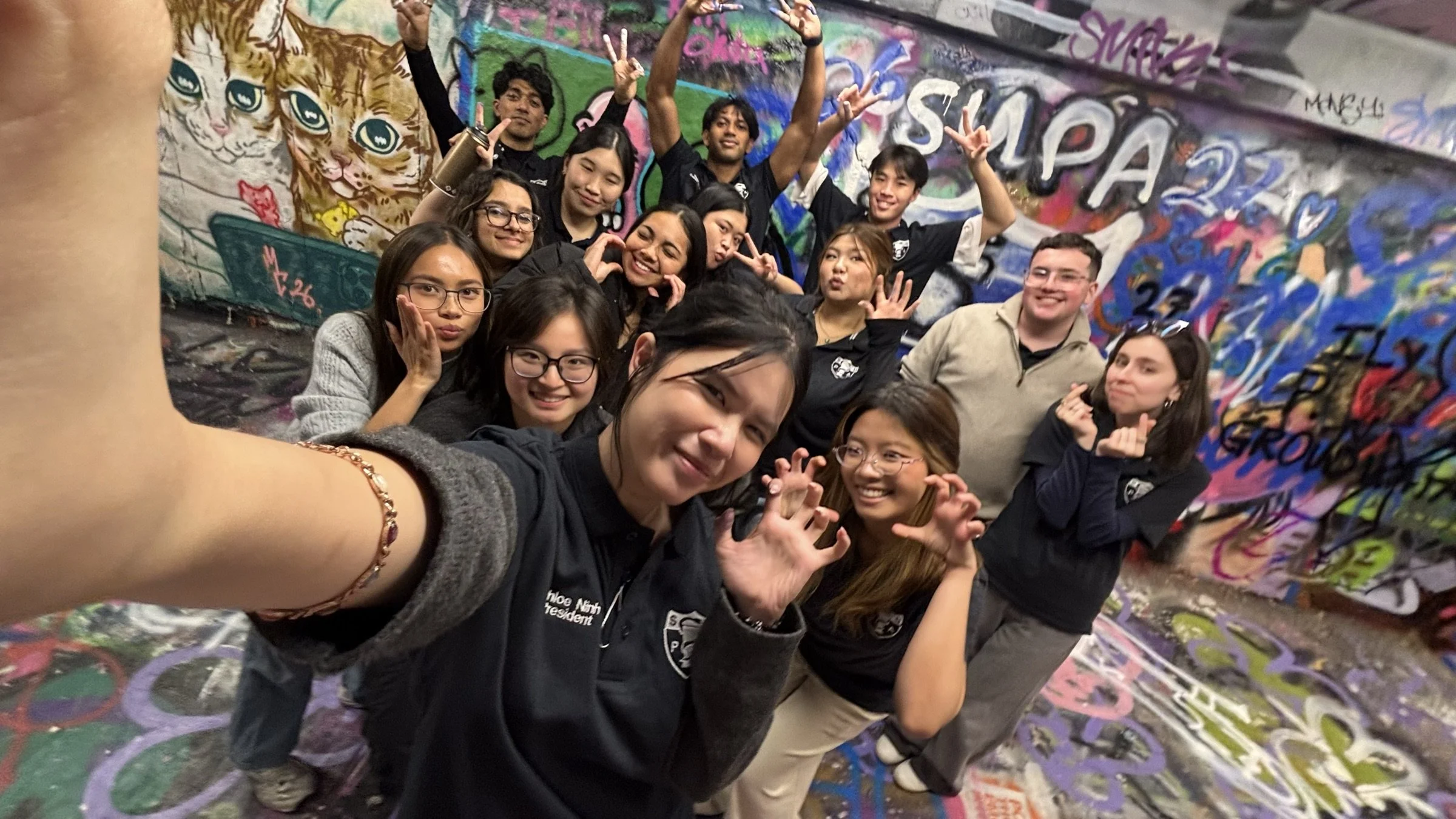 SUPA students together at the painted campus mural