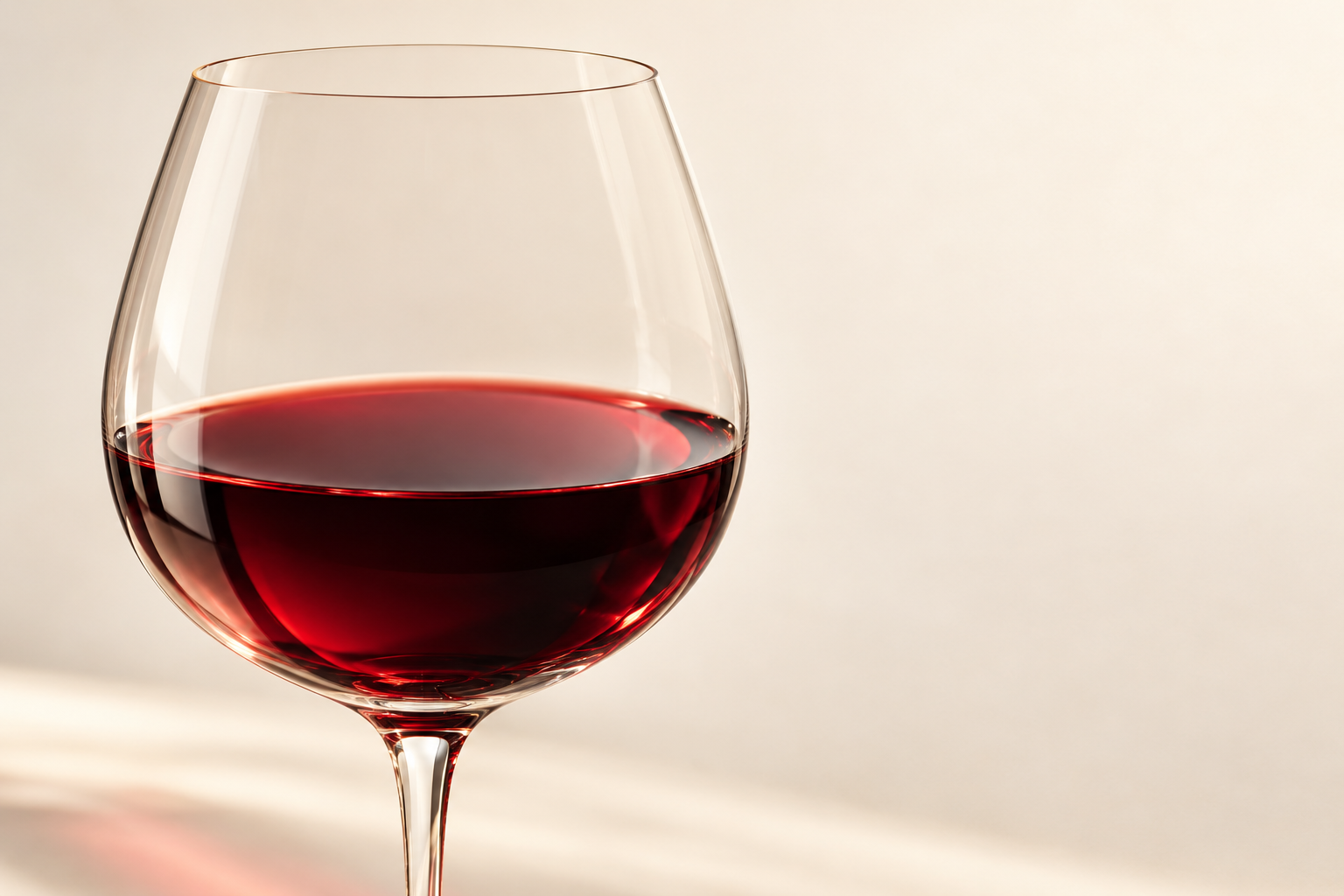 Illustration of ruby wine in a glass with warm light.
