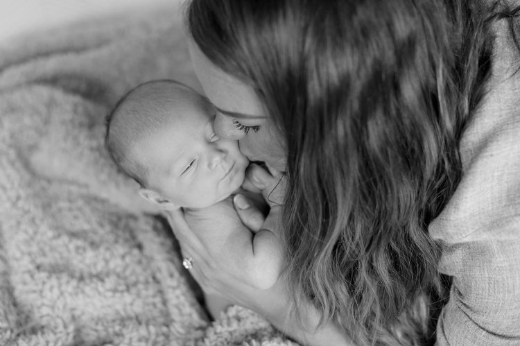 Mother holding her newborn baby close