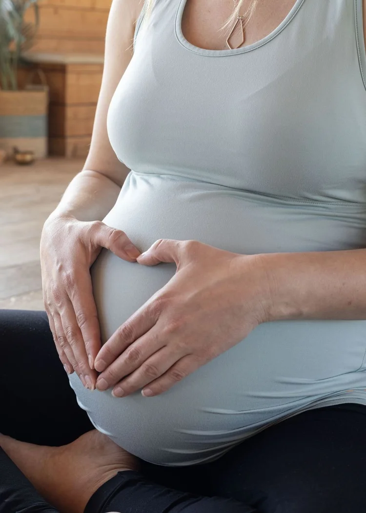 Close-up of hands resting on a pregnant belly