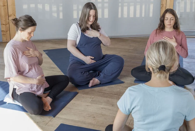 Group breathing practice with hands resting on the chest