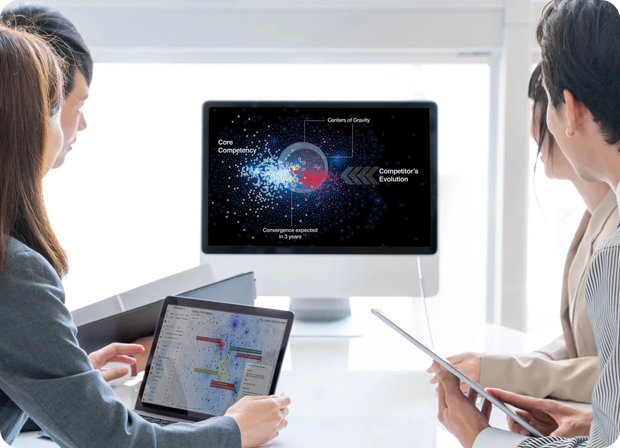 Two consultants reviewing a VALUENEX Radar patent landscape visualization on screen