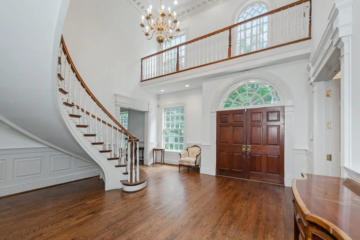 Two-story foyer with curved staircase
