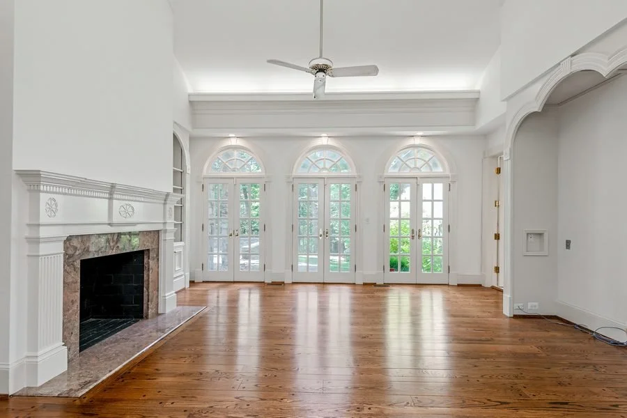 Bright living room with fireplace and arched windows