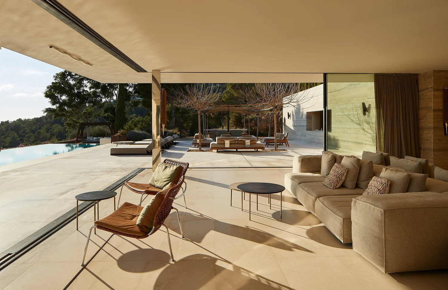 Salón y terraza de Can Kef con vistas hacia la piscina.