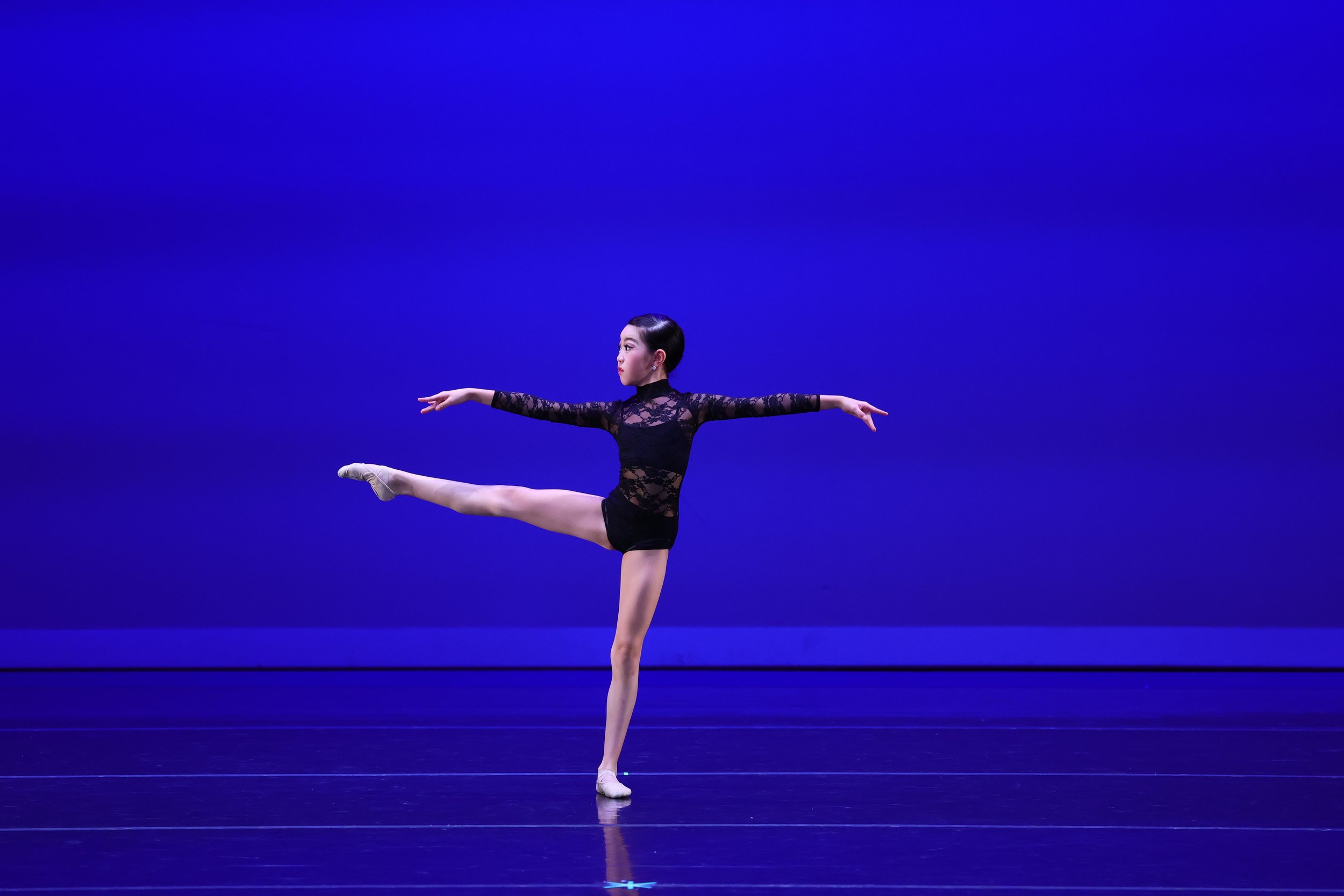 Lydia Huang in expressive contemporary ballet movement during Whispers of the Soul at CYB