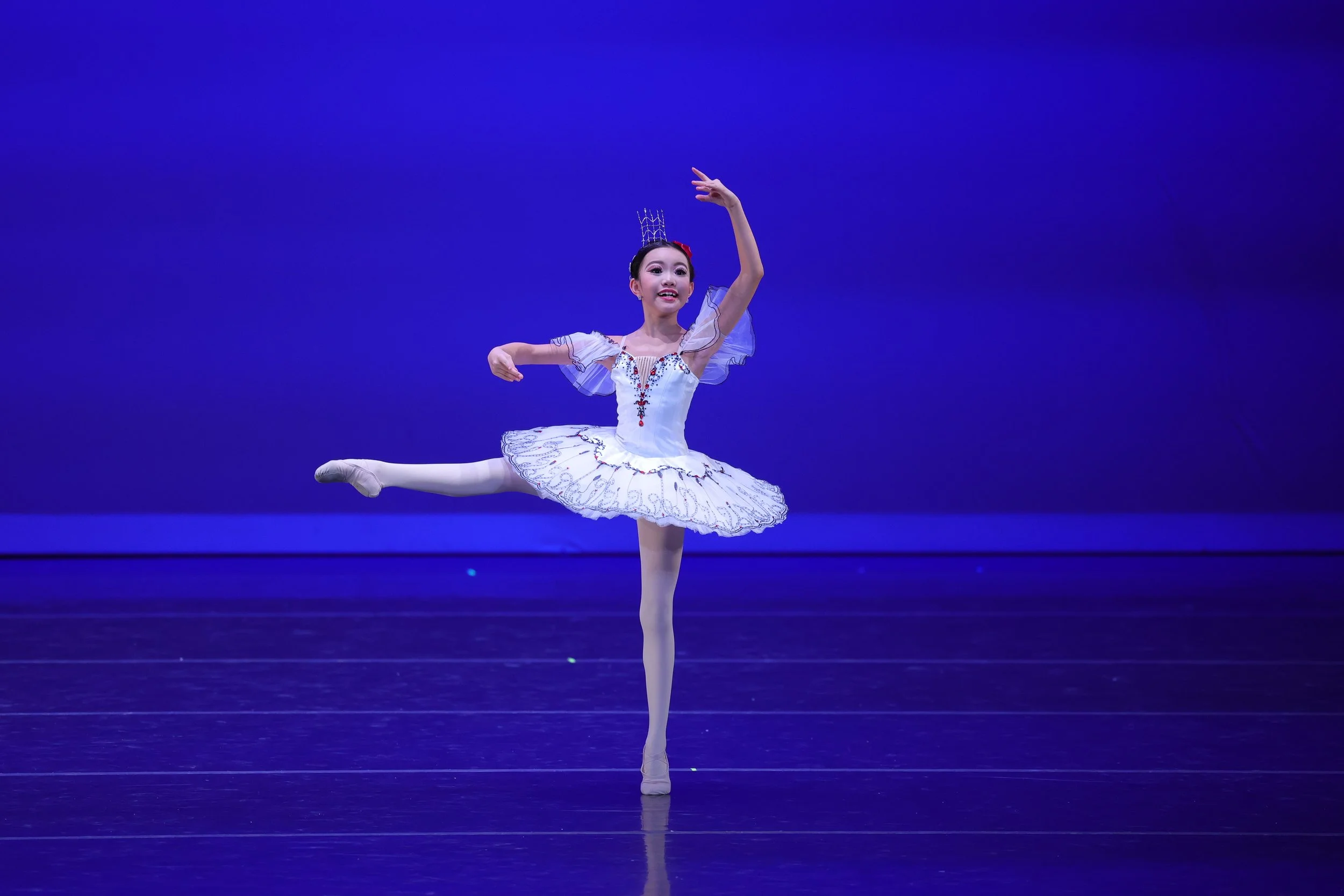 Lydia Huang performing the Paquita classical ballet variation on stage at Columbia Youth Ballet