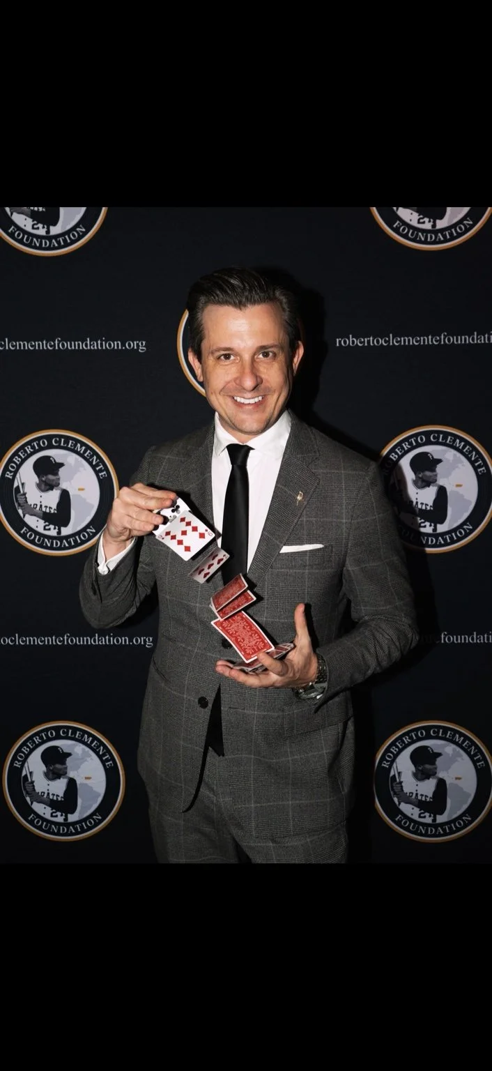 Lee Terbosic performing a card flourish at a Roberto Clemente Foundation event