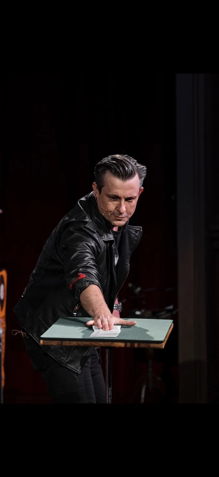Lee Terbosic performing card magic at his close-up table inside Liberty Magic