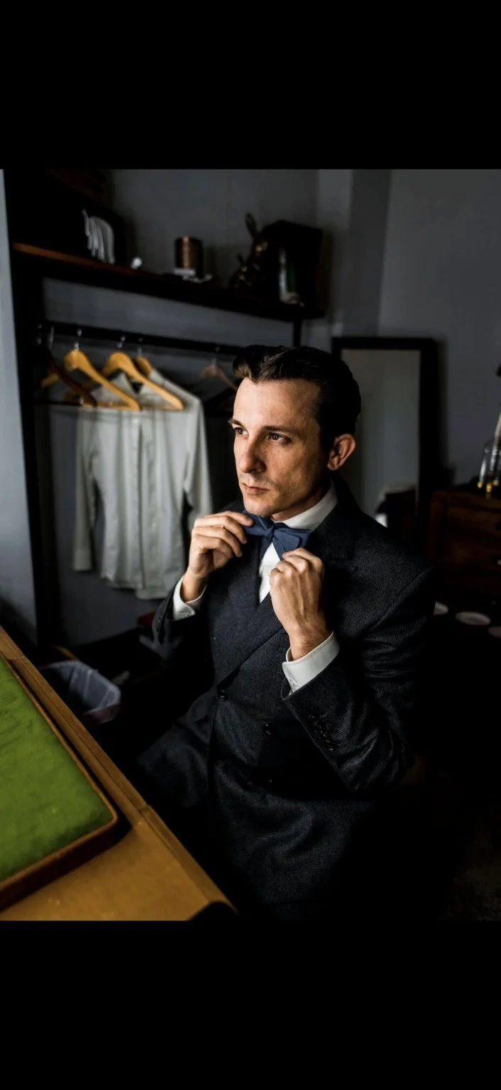 Lee Terbosic as Harry Houdini, adjusting his bow tie backstage