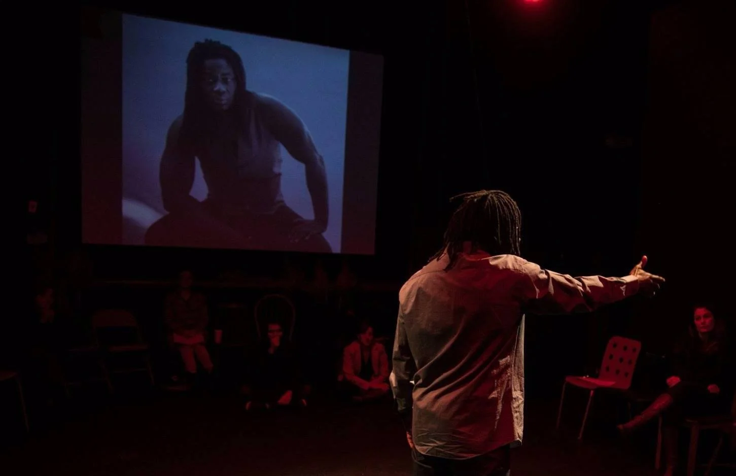 On stage, arm extended to the audience