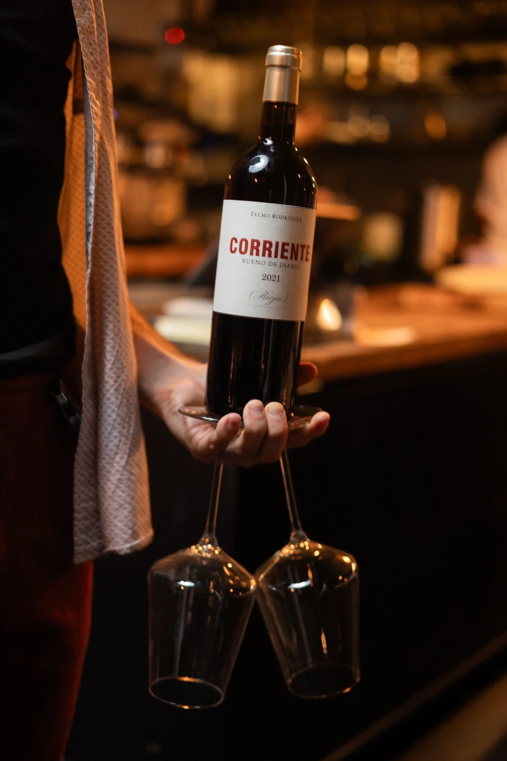 A bottle of red wine being presented at Salut