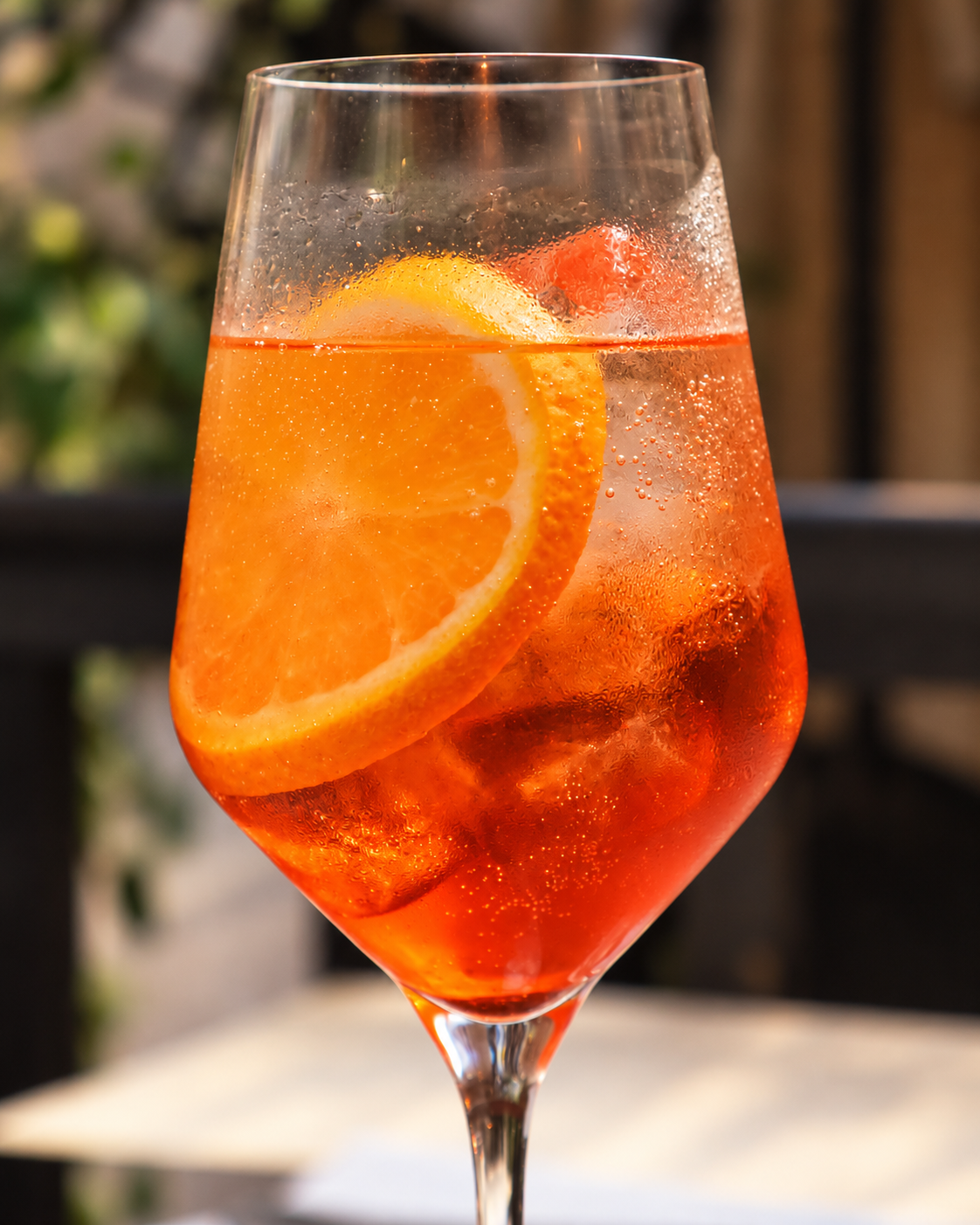 An orange cocktail with citrus and ice at Salut in Islington
