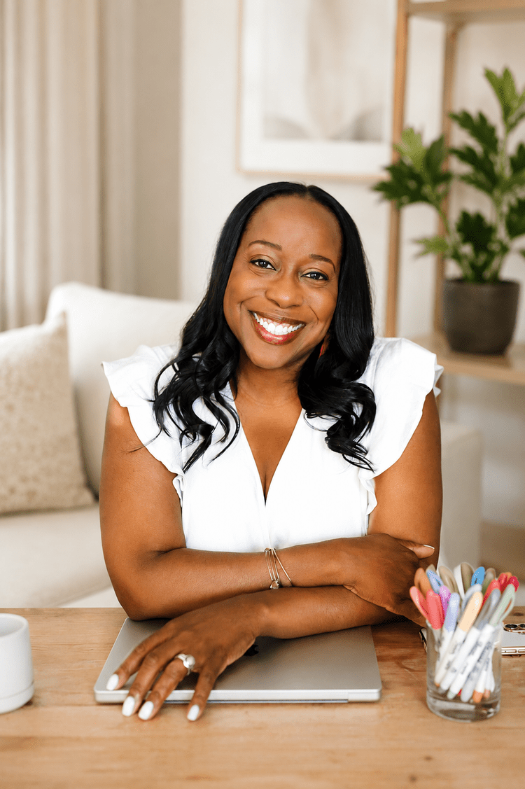 Monique Stevens smiling at her desk