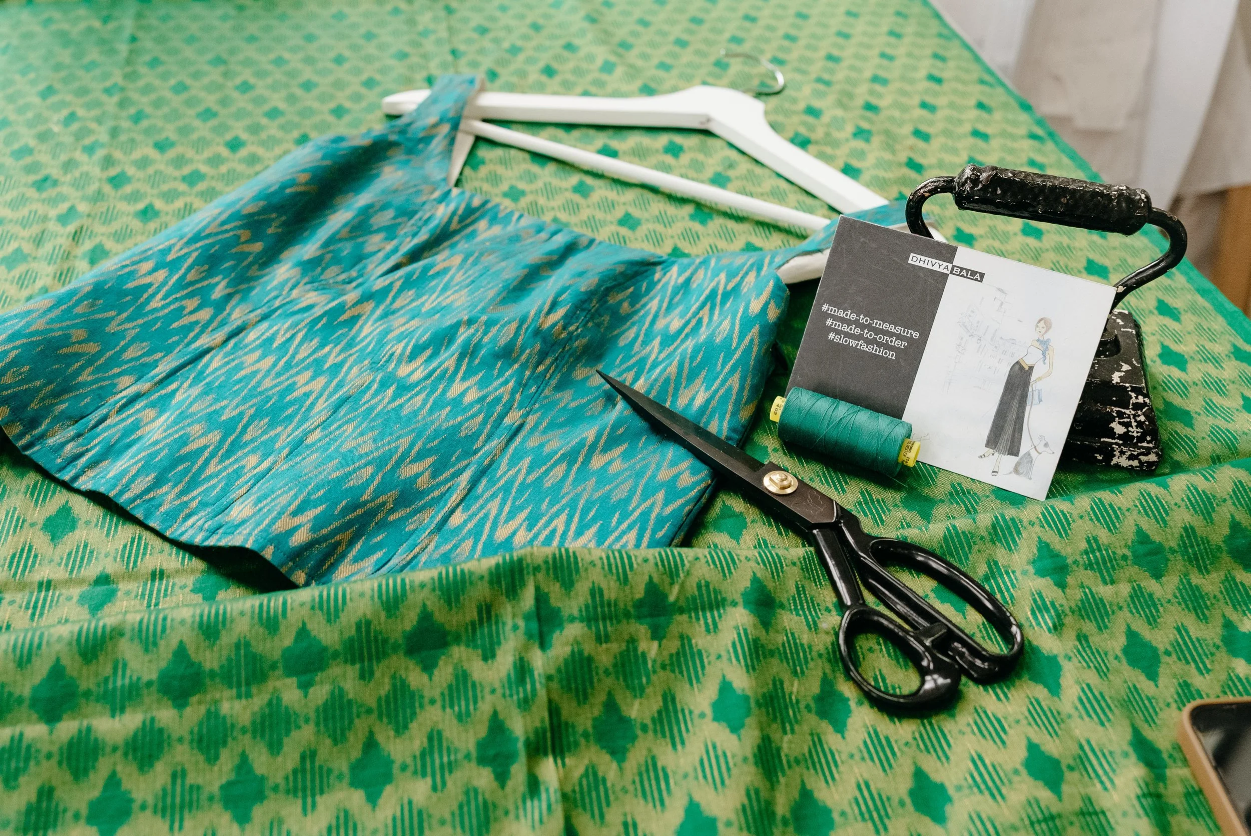 Green sari fabric with scissors