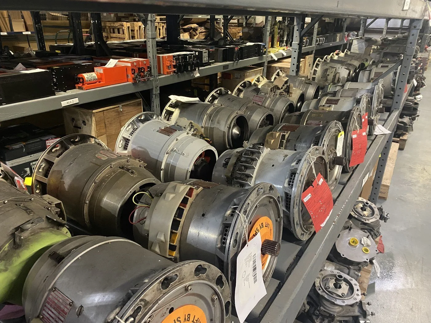 Rows of aircraft generators, tagged and binned on Skylink warehouse racks