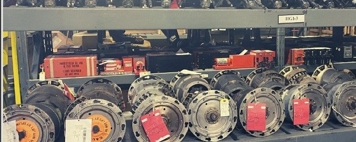Aircraft wheels and brakes with repair tags on a Skylink warehouse shelf