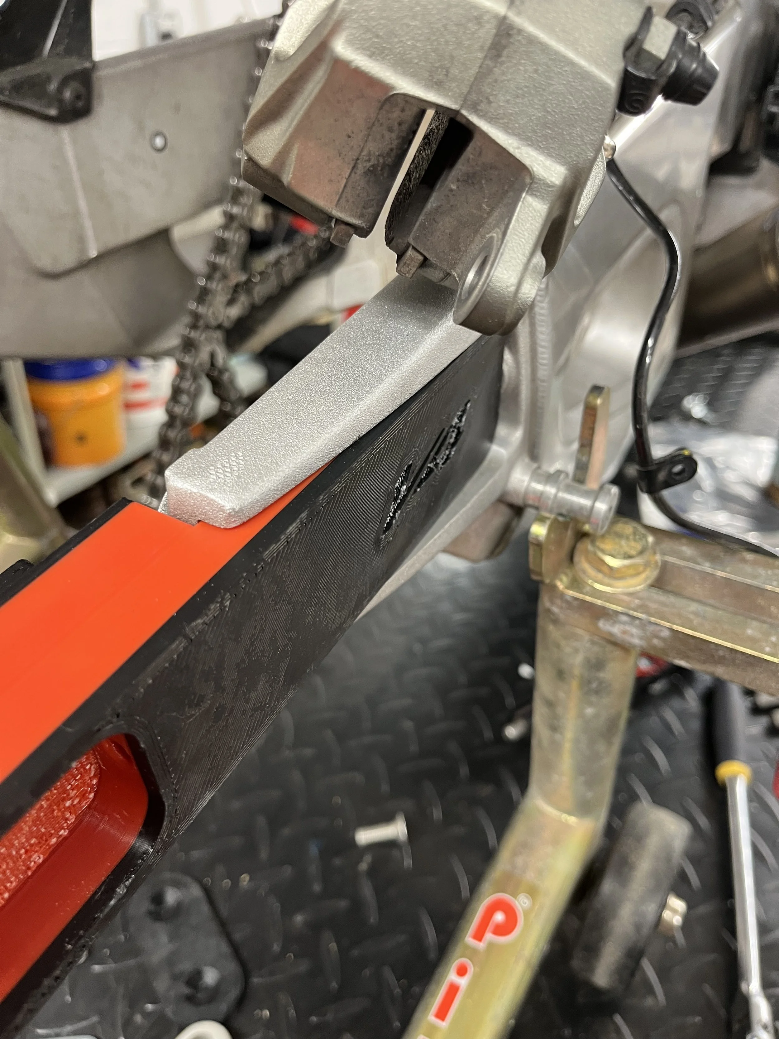 FDM 3D printed prototype swingarm extension installed on Aprilia V4 swingarm for fitment validation