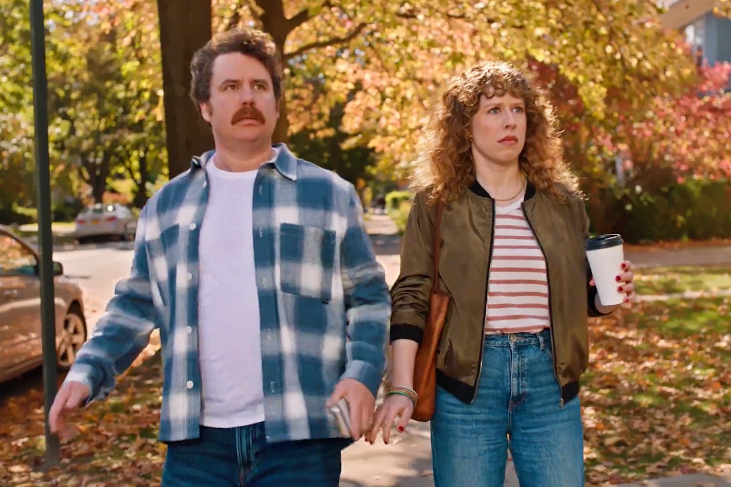 Scott Watson and Amanda Lea Mason walking through a fall neighborhood in the Ticketmaster NFL commercial.